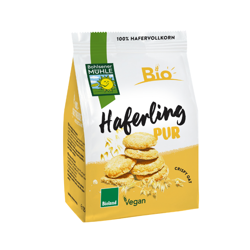 Eine Packung Haferling Pur von Bohlsener Mühle mit stapelbaren, knusprigen Hafer-Cookies und Haferähren abgebildet.
