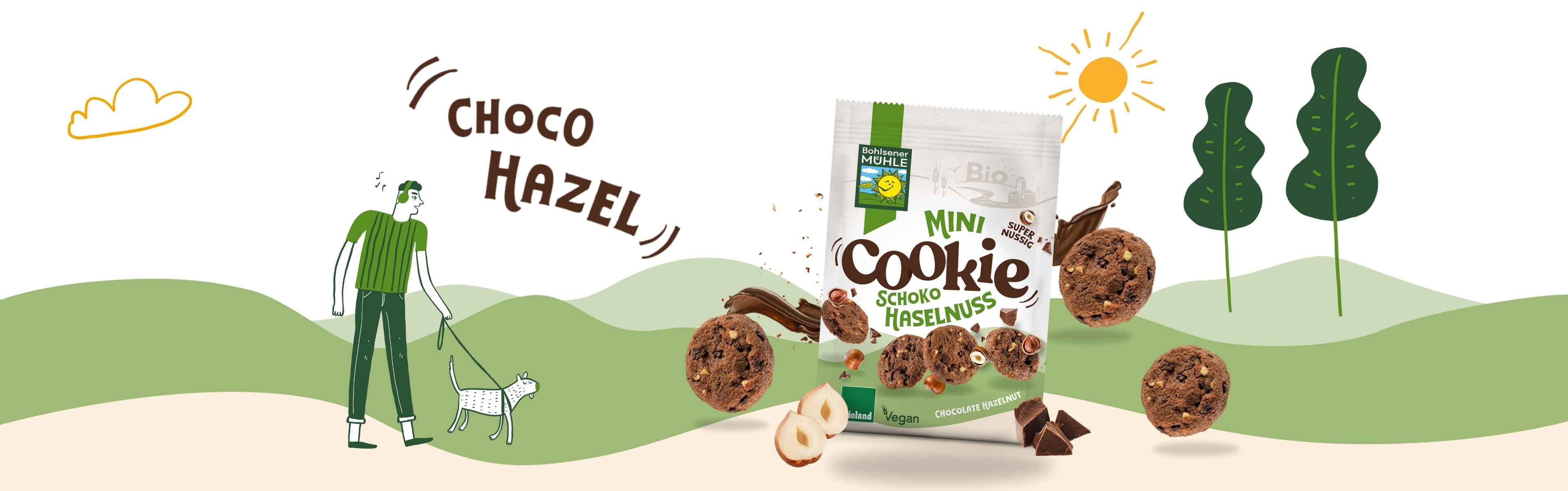 Bohlsener Mühle Mini Cookie Schoko Haselnuss in einer bunten Landschaft mit Hund.