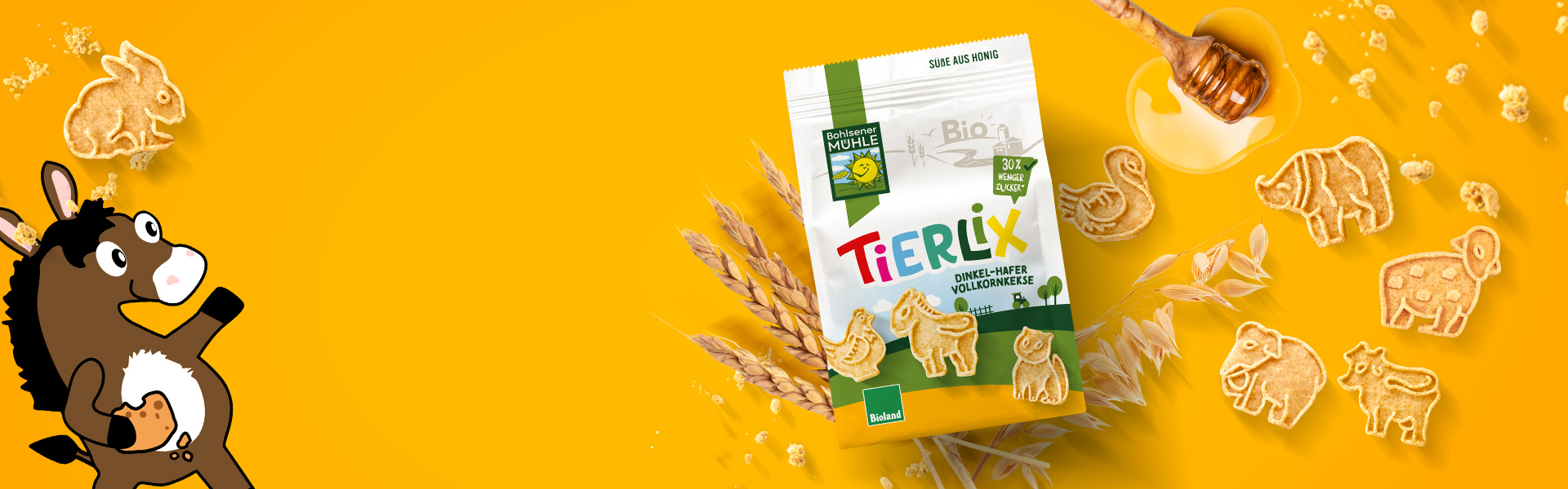 Bohlsener Mühle Tierlix Dinkel-Hafer Vollkornkekse mit Honig und tierförmigen Keksen auf gelbem Hintergrund.