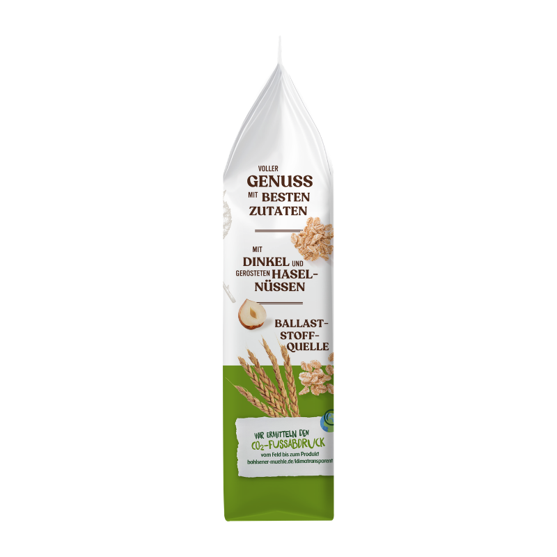 Die Bohlsener Mühle Dinkel Crunchy Haselnuss Packung zeigt Dinkelähren, Haselnüsse und knusprige Getreidestücke.