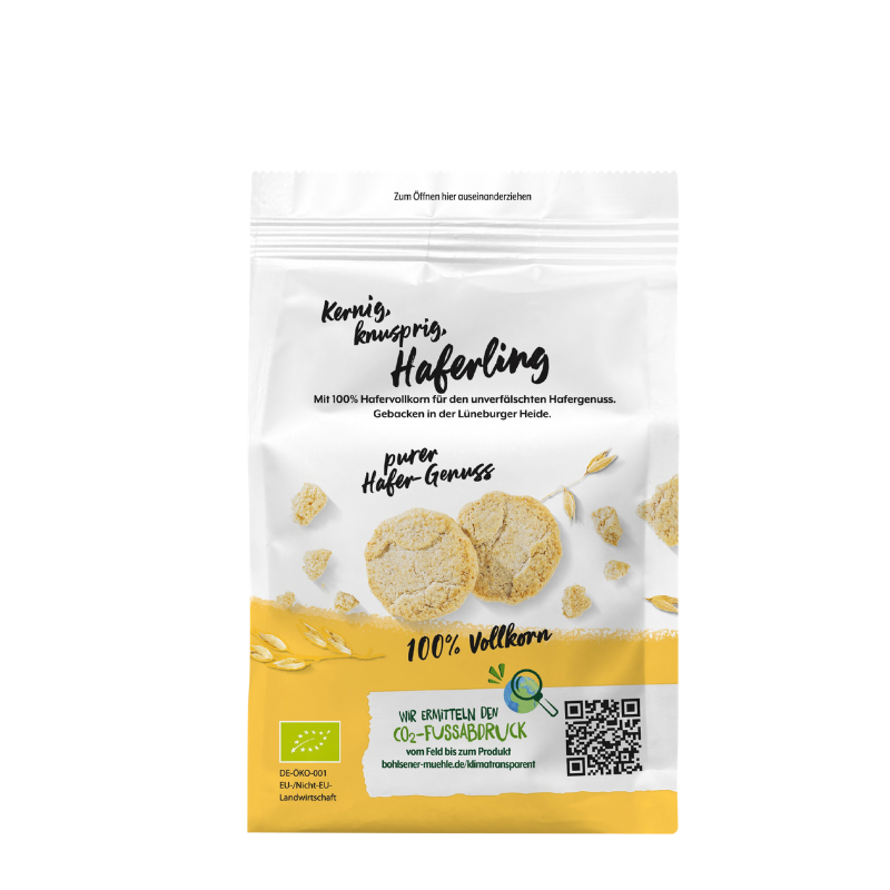 Die Packung Haferling von Bohlsener Mühle zeigt zwei kernige, knusprige Hafer-Cookies und Haferähren auf weißem Grund.