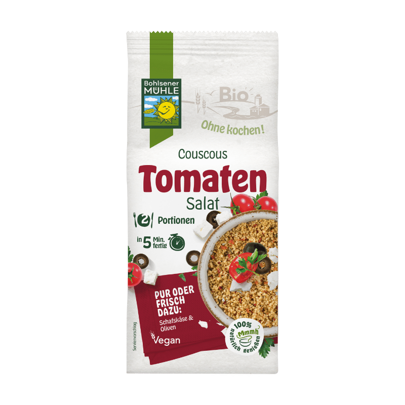 Bohlsener Mühle Couscous Tomatensalat in einer Schüssel mit Tomaten und Oliven.