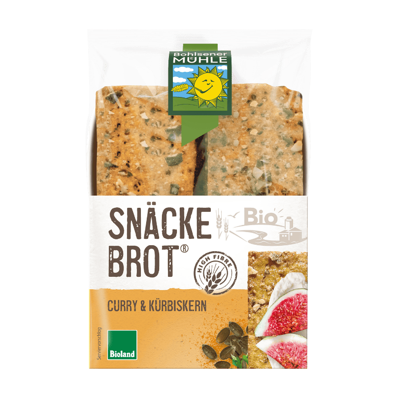 Bohlsener Mühle Snäcke Brot Curry & Kürbiskern in der Verpackung mit Feigenscheiben und Kürbiskernen dekoriert.