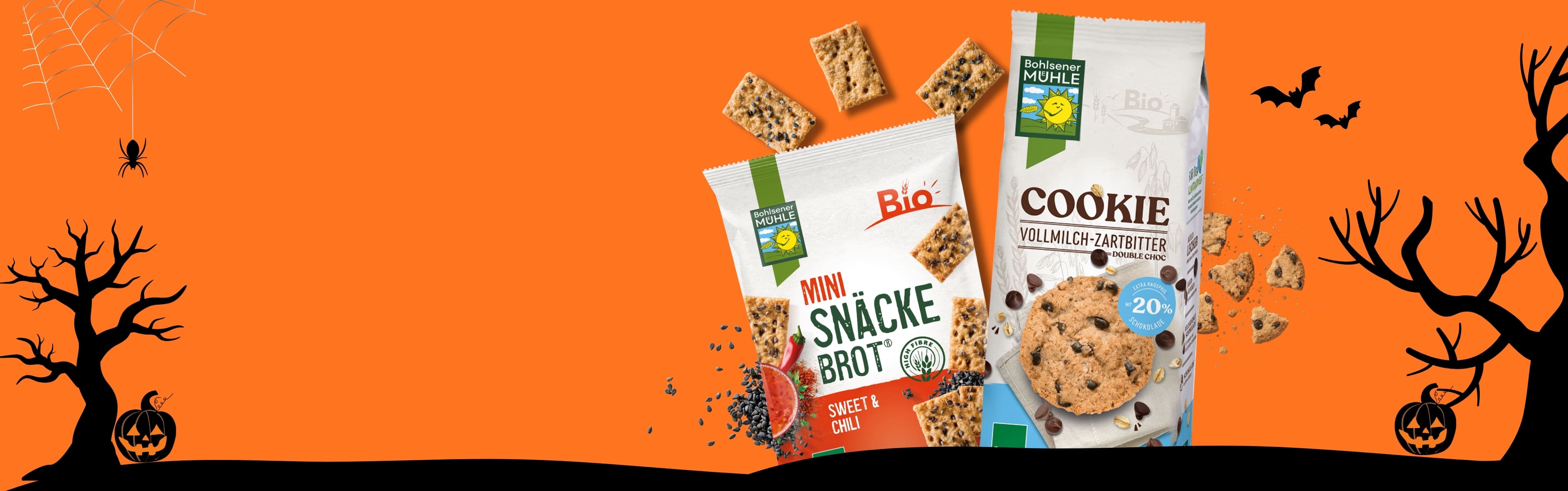 Bohlsener Mühle Mini Snäcke Brot und Cookie Vollmilch-Zartbitter vor einem orangefarbenen Halloween-Hintergrund.