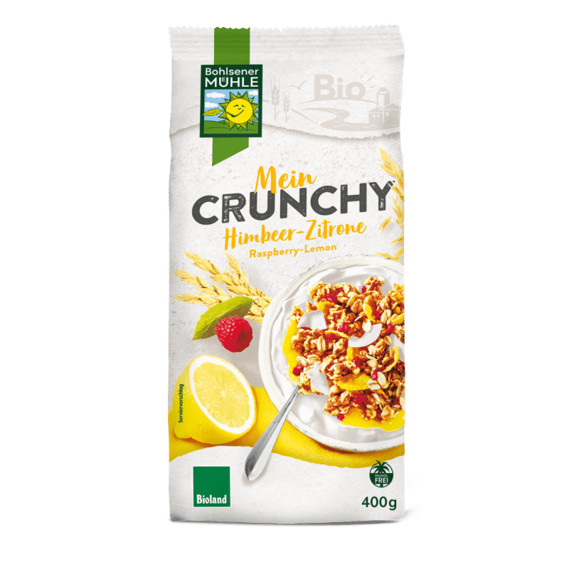 Bohlsener Mühle Mein Crunchy Himbeer-Zitrone in einer Schüssel mit Himbeeren und Zitrone.