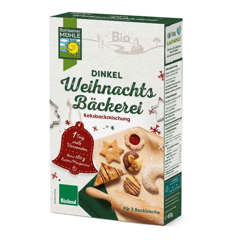 Die Bohlsener Mühle Dinkel Weihnachts Bäckerei Keksbackmischung mit verschiedenen gebackenen Keksen auf einem Tisch.