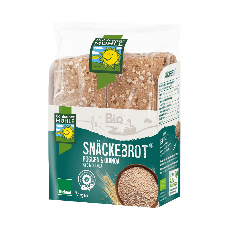 Eine Packung Bohlsener Mühle Snäckebrot Roggen & Quinoa mit einer kleinen Schale voller Quinoakörner davor.